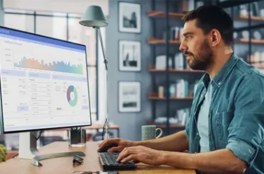 Ein Controller sitzt vor einem Bildschirm mit Zahlen und Statistiken